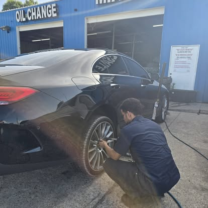 Miami Wholesale Tires technician installing a wheel